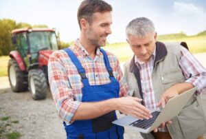 Farmer holding a laptop