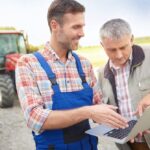 Farmer holding a laptop
